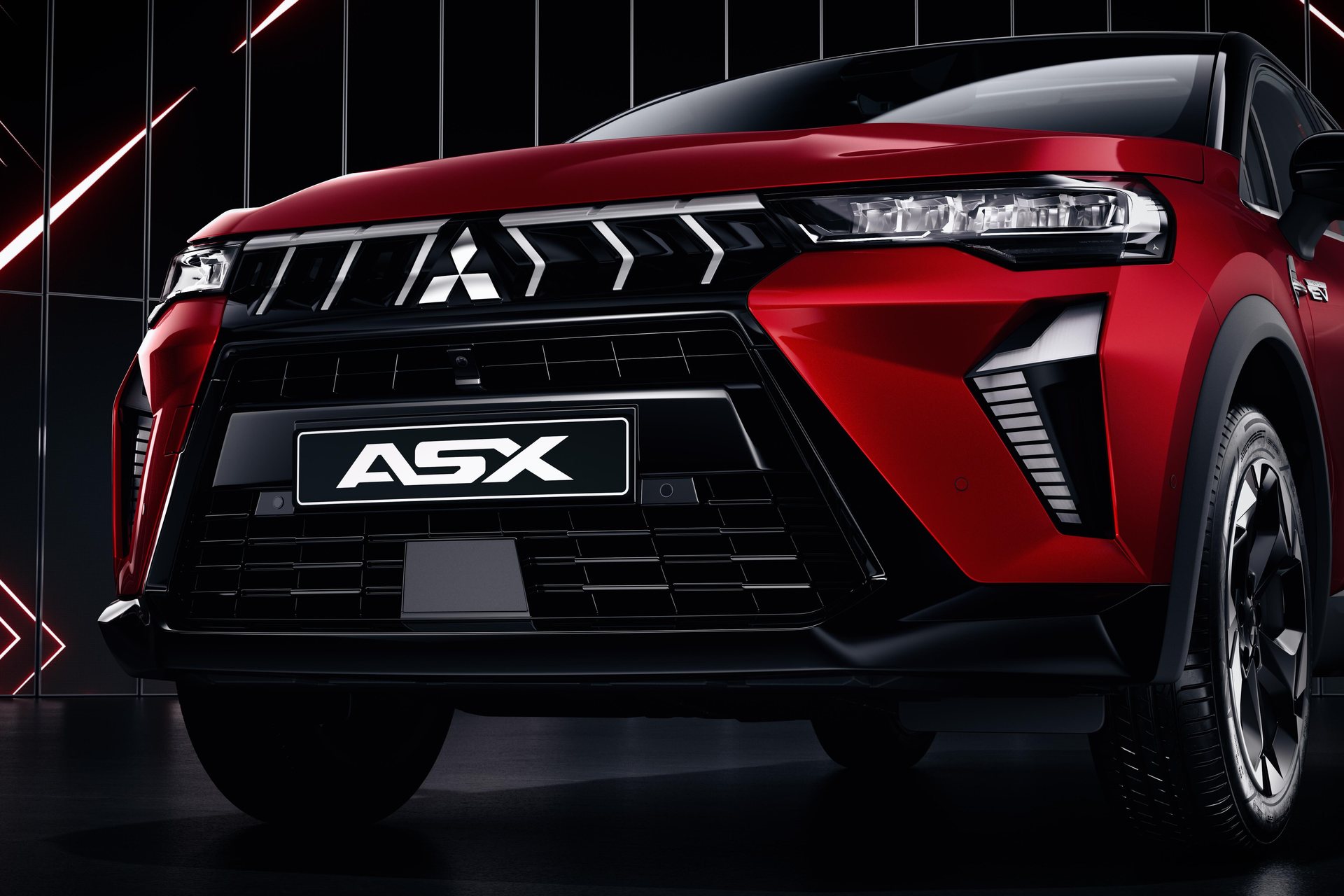 Dianteira do Mitsubishi ASX vista de três quartos, com a grelha em lâminas e o emblema dos três diamantes